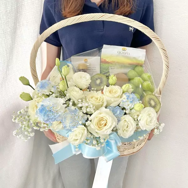 Fruit and flower basket with soy milk, lemongrass drink, honey, and chrysanthemums.