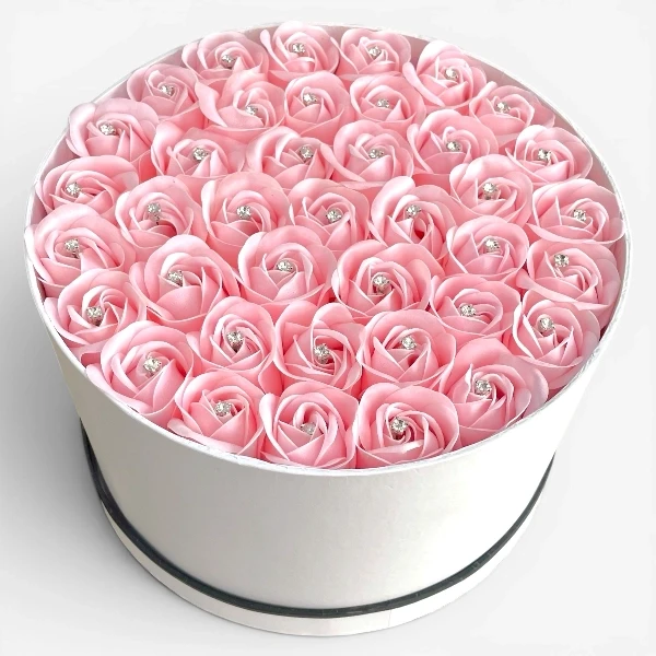 Round white box filled with 40 pink artificial roses, each with a diamond in the center.