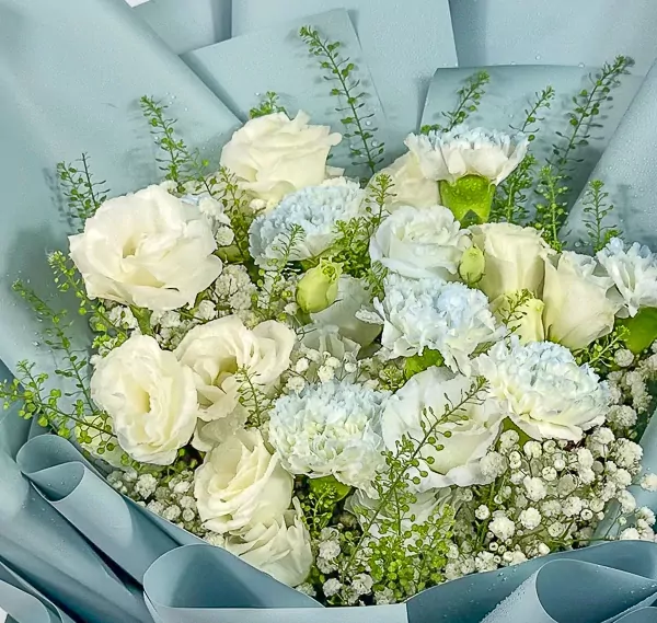 White roses, carnations, lisianthus, and gypsophila in a light blue bouquet with blue wrapping.