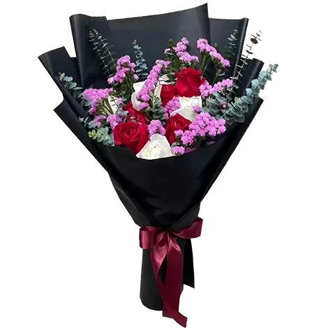 A bouquet of red and white roses with purple statice flowers, wrapped in black paper and tied with a burgundy ribbon.