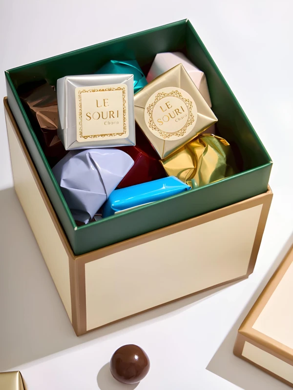 A Le Souri chocolate gift box filled with individually wrapped chocolates in various colors.