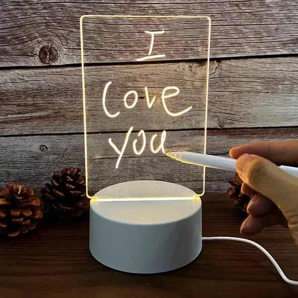 A clear lamp with "I love you" written on it in white, lit from a white base.