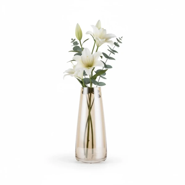 Amber glass vase with white lilies and eucalyptus sprigs on a white background.