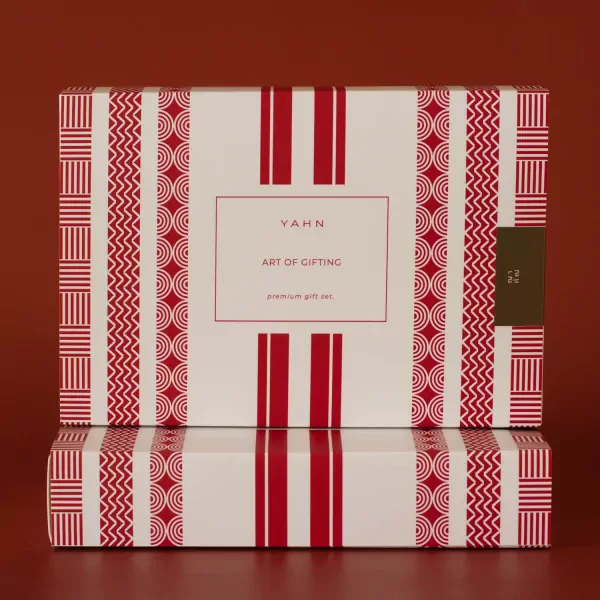 Gift box with red and white geometric pattern and "YAHN ART OF GIFTING" text.