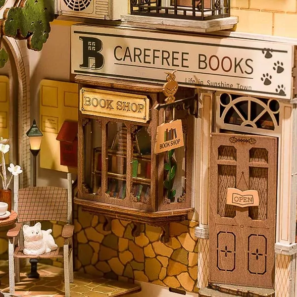 Miniature wooden bookshop scene with "Carefree Books" sign and "Book Shop" window display.