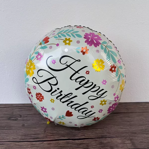 A round, white balloon with colorful flowers and "Happy Birthday" in script.