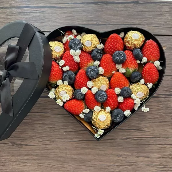 Heart-shaped box of strawberries, blueberries, and Ferrero Rocher chocolates.