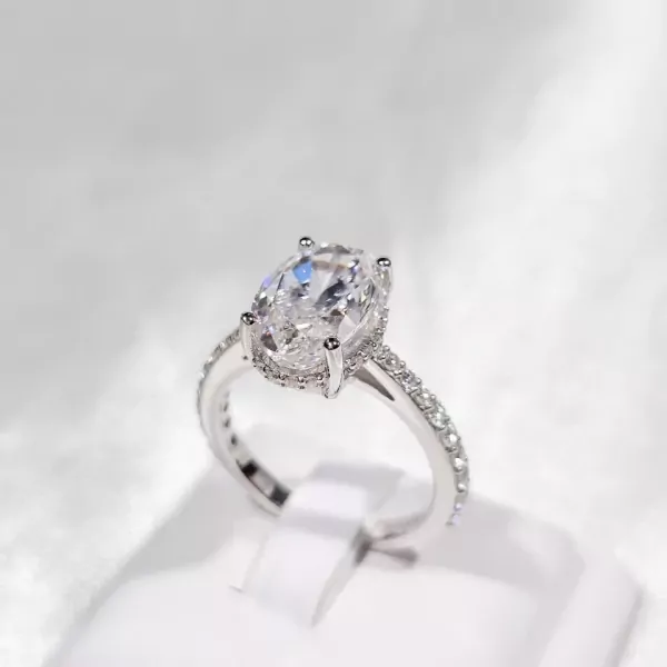 Oval-cut moissanite diamond ring with a white gold plated sterling silver band.