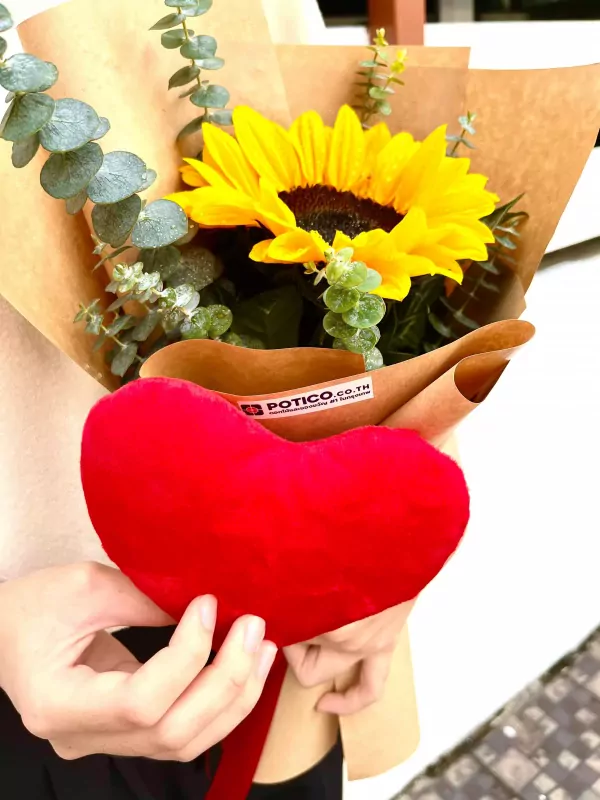 Red velvet heart pillow with a sunflower bouquet.