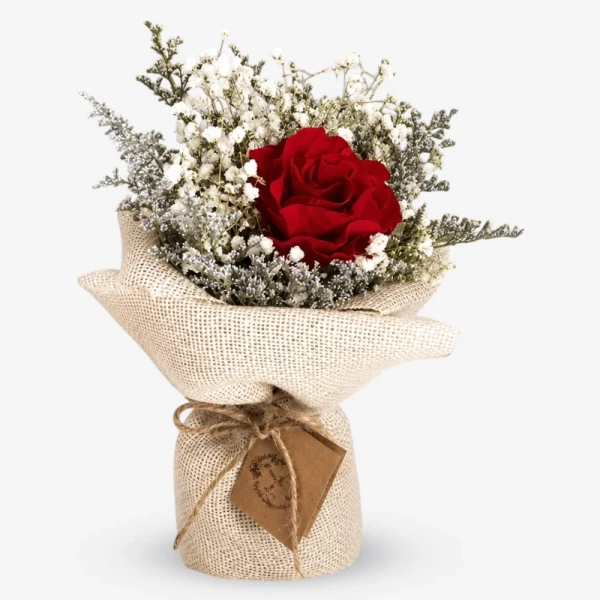 dried red rose bouquet with white baby's breath, wrapped in burlap.