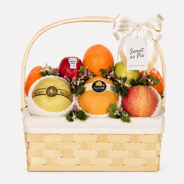 A woven basket filled with fresh, assorted fruits including pears, apples, and mandarins.