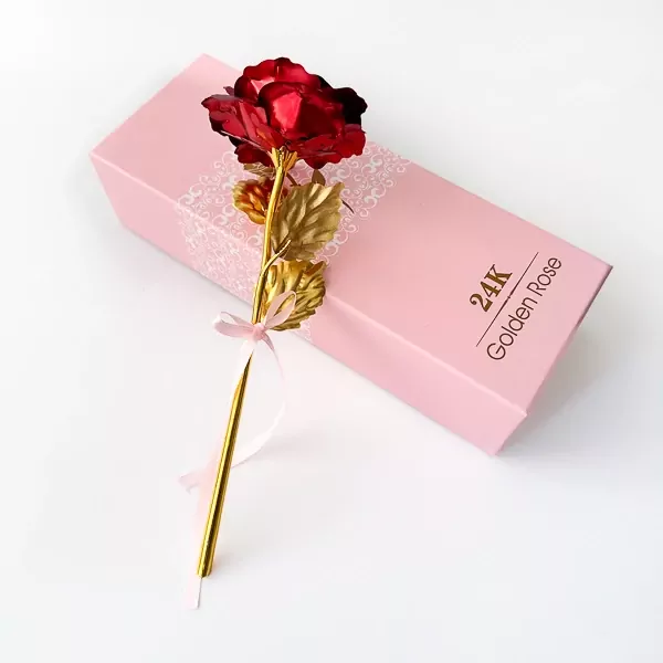 Red and gold artificial rose with a pink ribbon on a pink gift box that reads "24K Golden Rose".