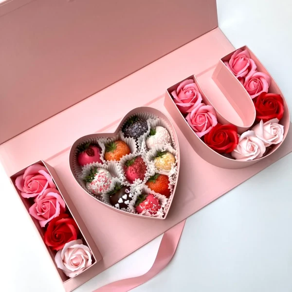 "I Love You" box with heart-shaped chocolate-covered strawberries and pink and red artificial roses.