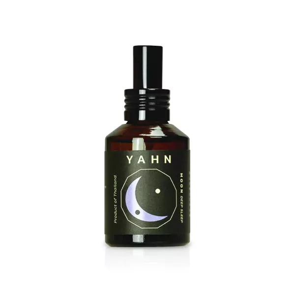 Dark amber glass spray bottle with a black label featuring a crescent moon and "YAHN MOON DEEP SLEEP".