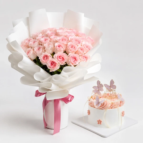 Pink rose bouquet and mini cake with butterfly decorations.