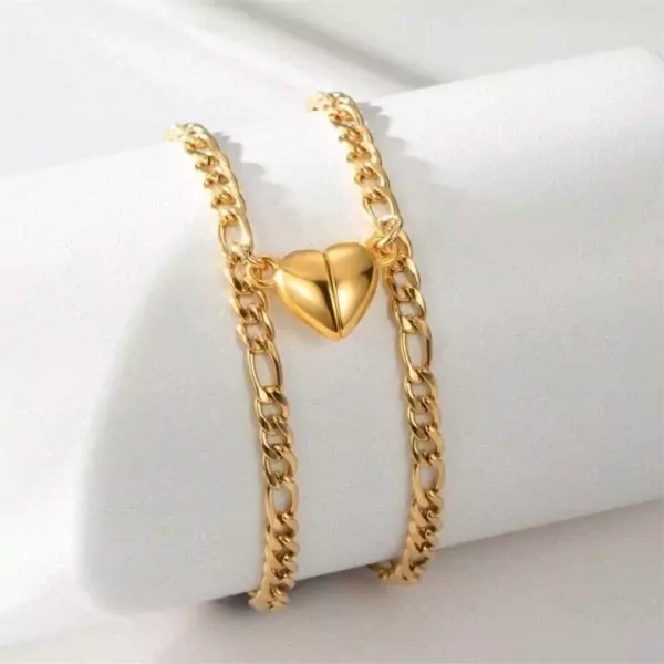 Gold chain bracelets with magnetic half-heart pendants that connect.
