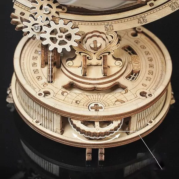 Wooden globe model with gears, showing a rotating mechanism and circular dial.