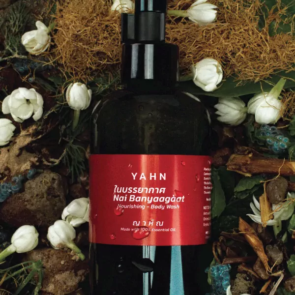 YA.H.N. nourishing body wash bottle with jasmine flowers and natural elements.