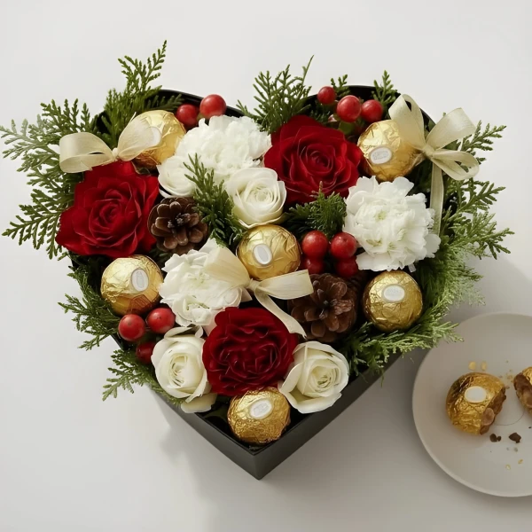 Heart-shaped box with red and white roses, carnations, pinecones, berries, and Ferrero Rocher chocolates.