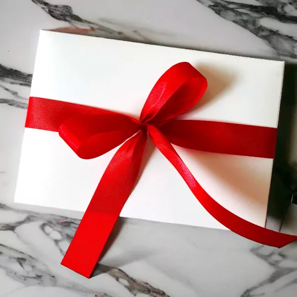 White box with red ribbon, gift-wrapped for chocolate strawberries.