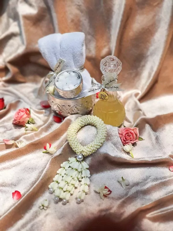 Thai Water Ceremony Set M: Jasmine garland, white towels, sugar cubes in silver bowl, and essence water bottle.