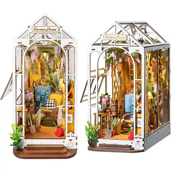 Two detailed wooden miniature garden houses with plants, furniture, and lights.