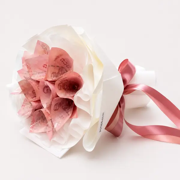 Bouquet of folded 1000 Thai Baht notes wrapped in white paper with a pink ribbon.