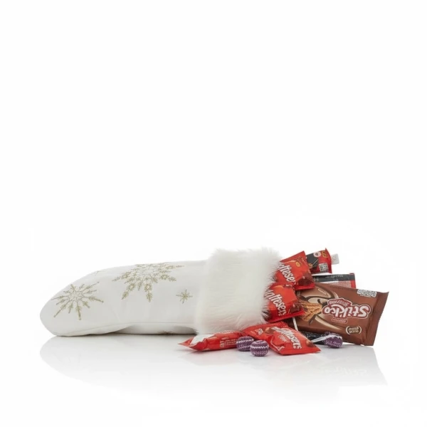 White Christmas stocking with gold snowflake embroidery, fur trim, filled with chocolates and candies.