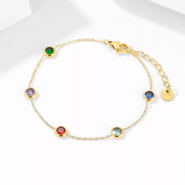 Gold chain bracelet with six colorful gemstones: green, purple, red, blue, and two light blue.