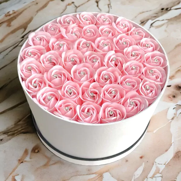 Round white box filled with 40 pink artificial roses, each with a diamond accent.