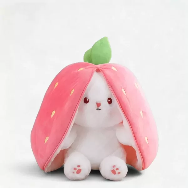 White plush rabbit wearing a pink strawberry costume with a green leaf on top.