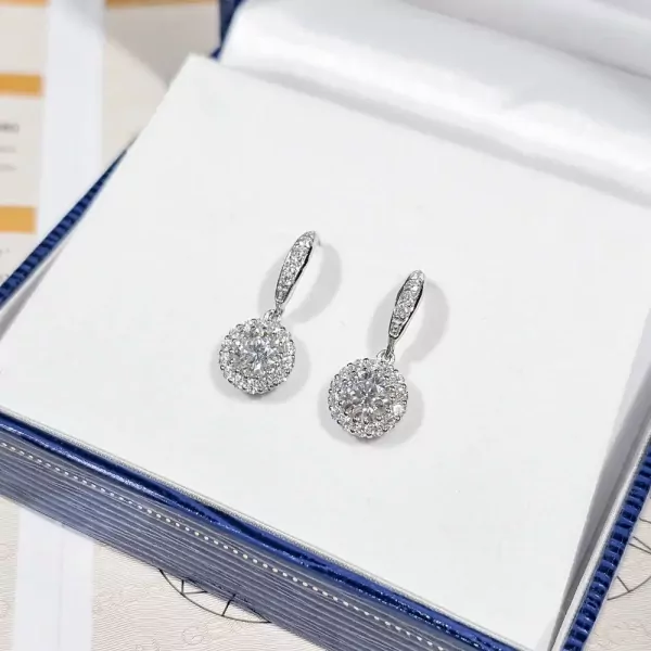 1-carat round-cut moissanite diamond halo drop earrings on a white surface.