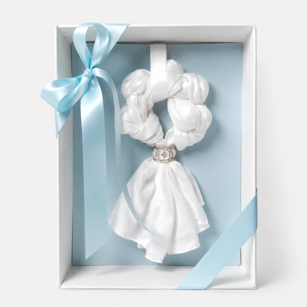 White silk scarf garland with blue ribbon accents in a gift box.