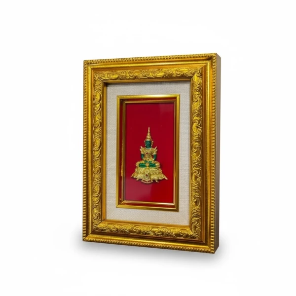 Framed Emerald Buddha in gold frame with red background and silk matting.