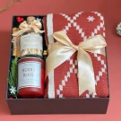 Christmas gift box with red knit scarf, Berry Bliss candle, and scented matches.
