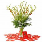 Red gladiolus and baby's breath flower arrangement with red envelopes.