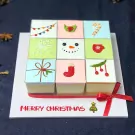 Nine Christmas-themed mousse desserts in a grid, decorated with festive icons and a "Merry Christmas" message.