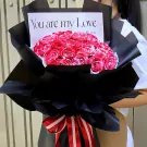 A bouquet of red and white marbled roses in black paper with "You are my Love" card and red/white ribbon.