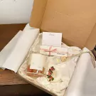 Scented candle gift set with candle, dried flowers, and note card.