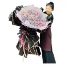 Woman holding a large bouquet of colorful baby's breath flowers.