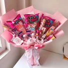 Pink candy bouquet with assorted snacks and candies.