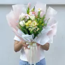 Still Life bouquet with white roses, pink tulips, and small white daisies.