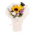 Bouquet with sunflower, roses, and a graduation-cap-wearing plush toy.