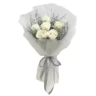 Bouquet of white roses with grey ribbon and decorative foliage.