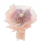 Pink baby's breath bouquet with a small bunny toy made of ping pong mums.