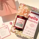 Valentine gift set with candle, dried flowers, and "hello Valentine" card.