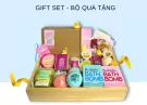 A gift basket overflowing with bath bombs, candles, and skincare products.