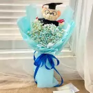 Graduation teddy bear bouquet with blue baby's breath flowers and light blue wrapping.