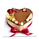 Heart-shaped tiramisu cake decorated with strawberries, grapes, raspberries, and white chocolate cubes.
