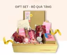 Gift set with bath bomb, bubble bath, dried roses, and a handwritten note.